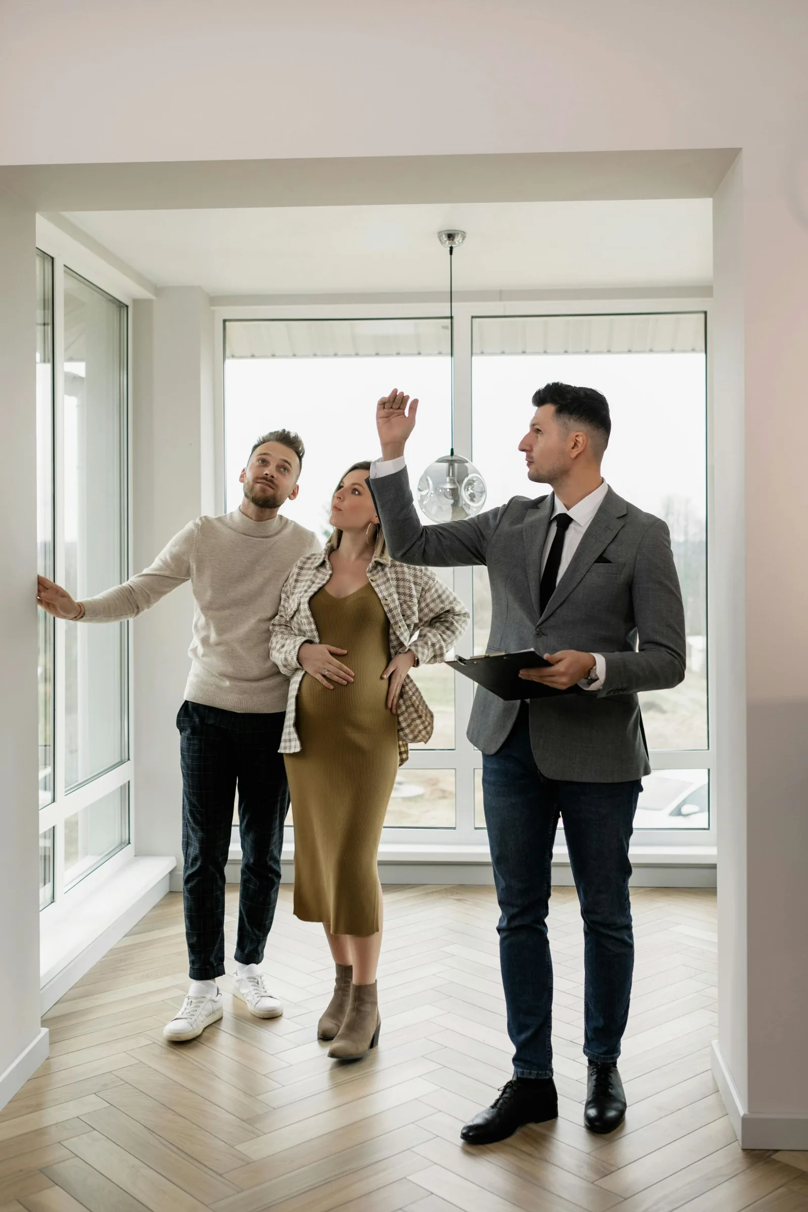 Real estate agent showing a home to a young couple