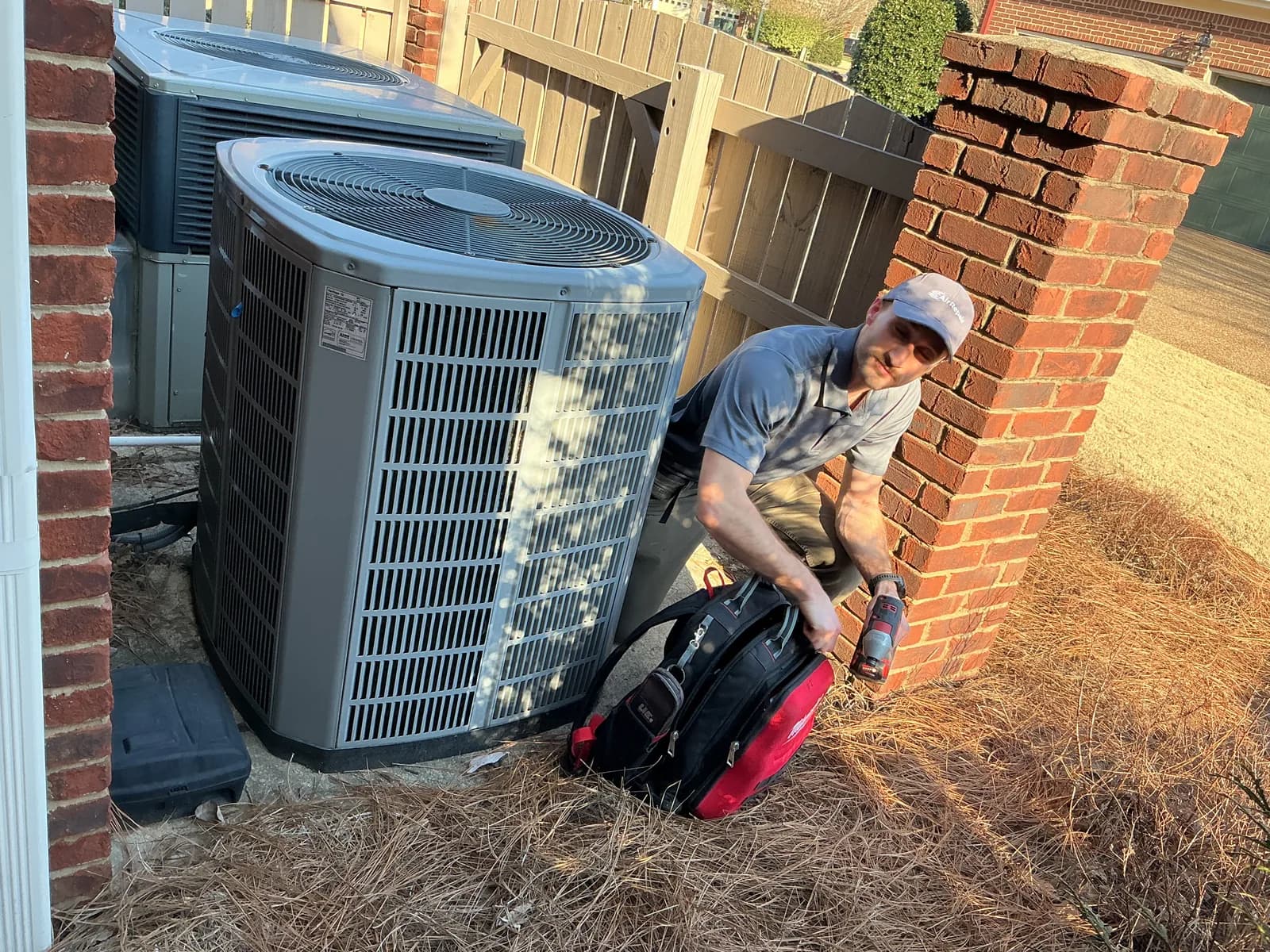 AirRepair technician servicing an outdoor AC unit at a Huntsville home